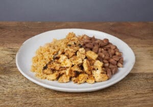 Image of a kids chicken, rice, and beans plate